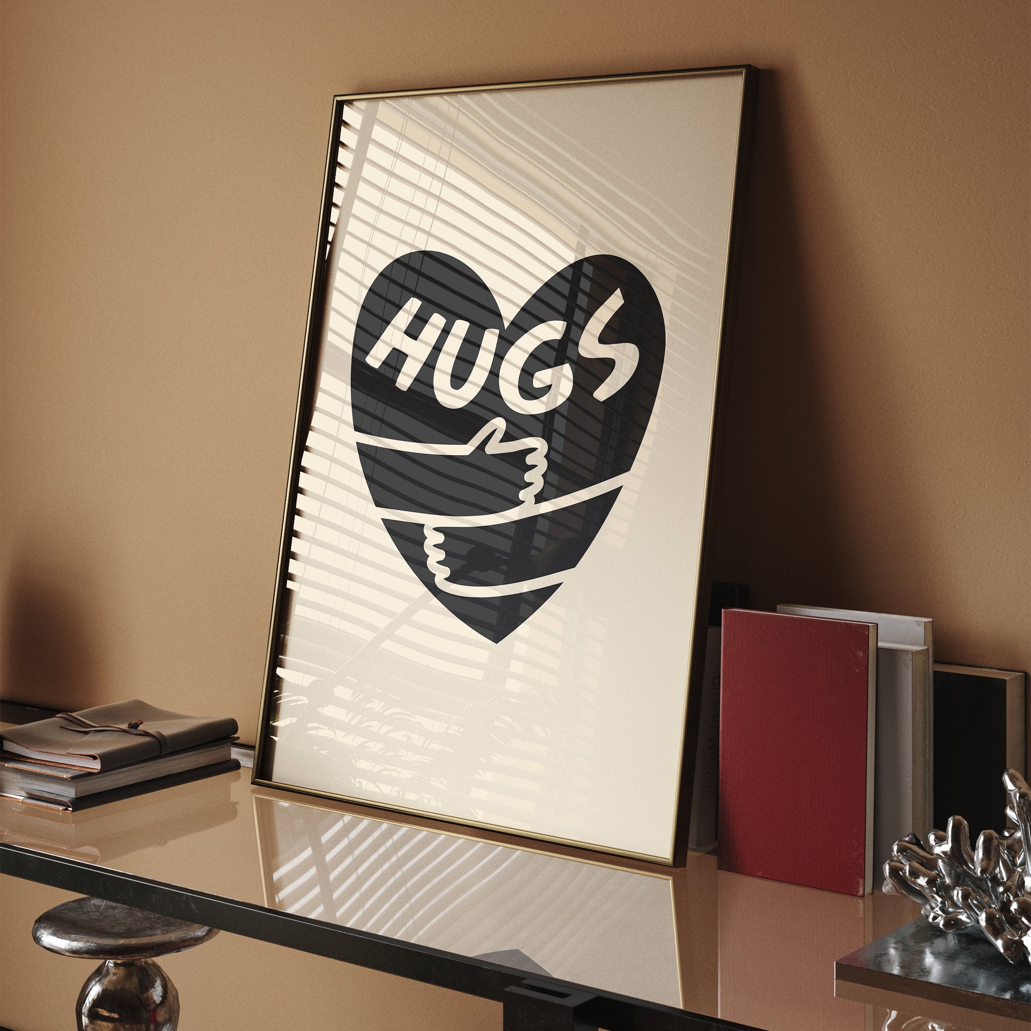 Simple black heart with 'Hugs' text and wrap-around arms on beige backdrop